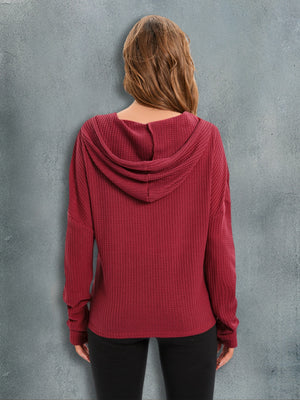 Red Orange waffle knit relaxed fit hoodie with a hood and long sleeves.