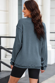 Textured ribbed crewneck pullover in Dusty Blue with long sleeves and a relaxed fit.