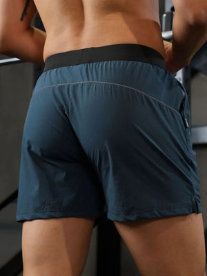 Peacock Blue athletic shorts with black waistband and reflective piping detail.