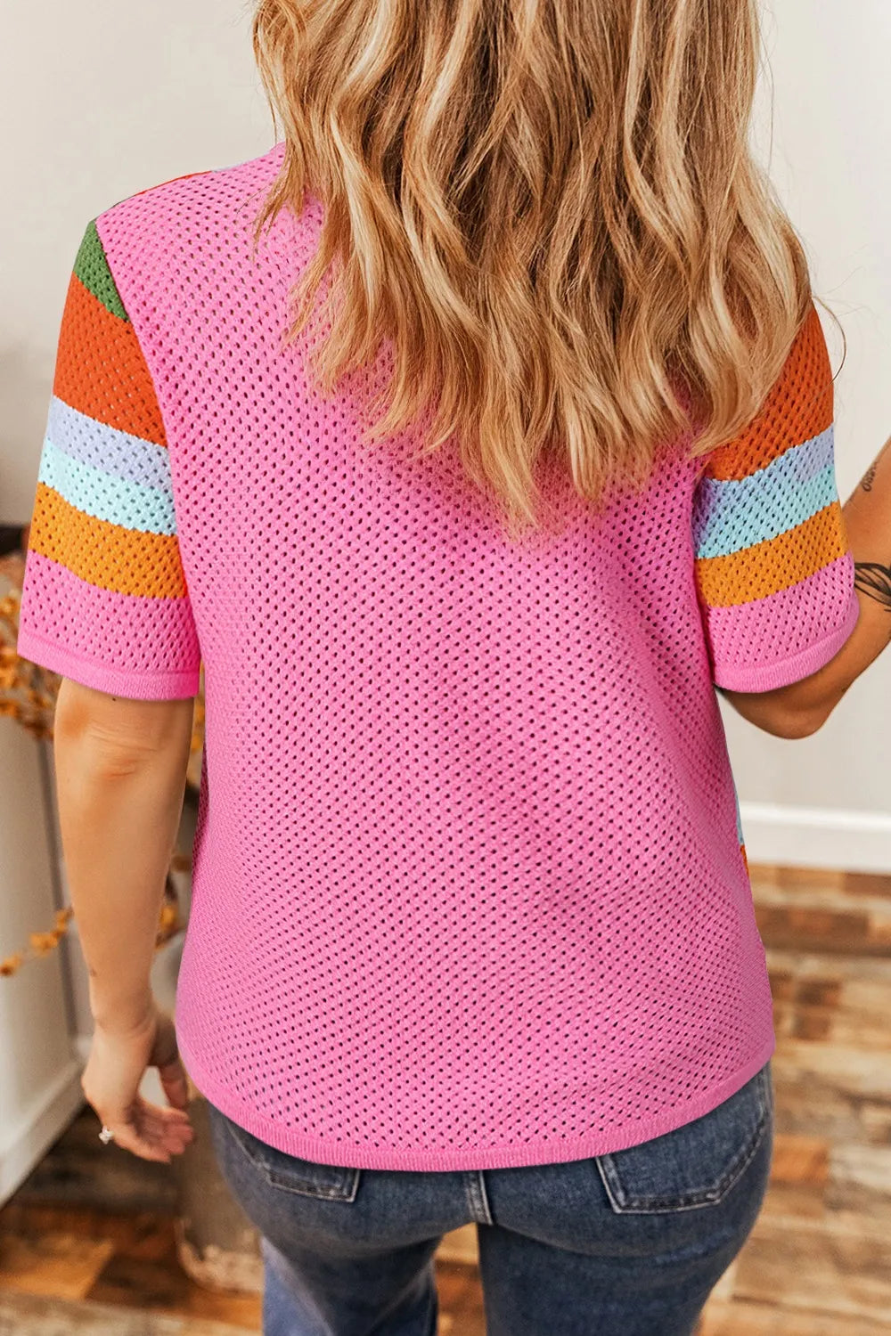 Geometric stripe openwork knit top in multicolor with short sleeves and a round neckline.