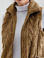 Camel faux fur zip-up vest with a stand-up collar, layered over a white turtleneck.