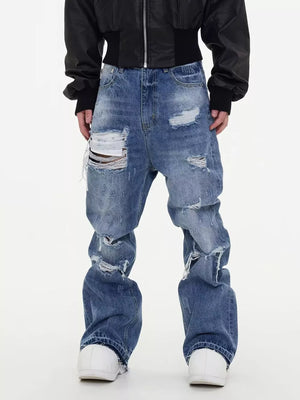 Distressed baggy fit men's blue cotton jeans with ripped details.
