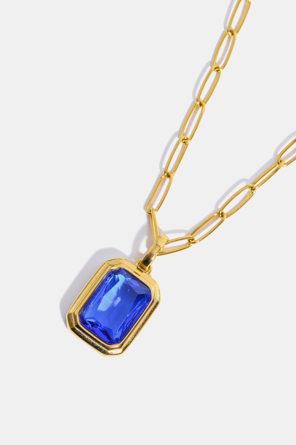 Gilded Prism Pendant Necklace with royal blue gemstone and 18K gold chain.