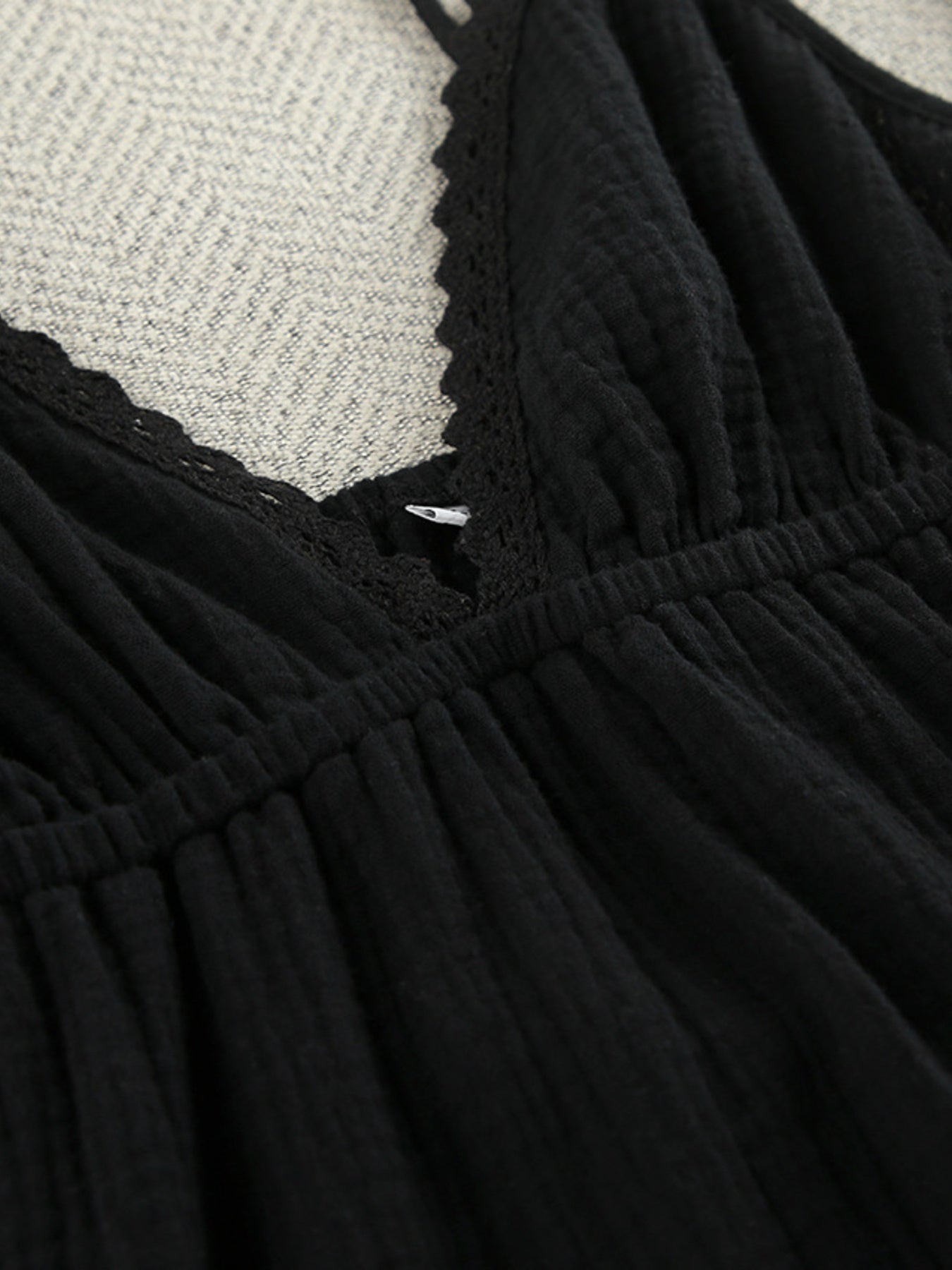 Black cotton tiered mini dress with lace trim detail at neckline