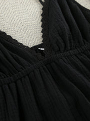 Black cotton tiered mini dress with lace trim detail at neckline