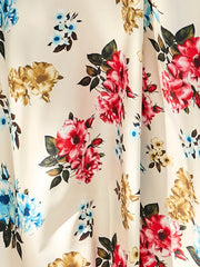 Chic floral midi dress with red, blue, and gold roses on a cream background.
