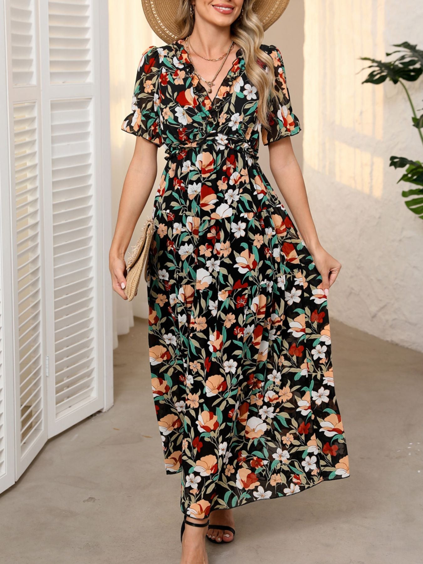 Black floral print maxi dress with V-neck, ruffles, short sleeves, and cinched waist.