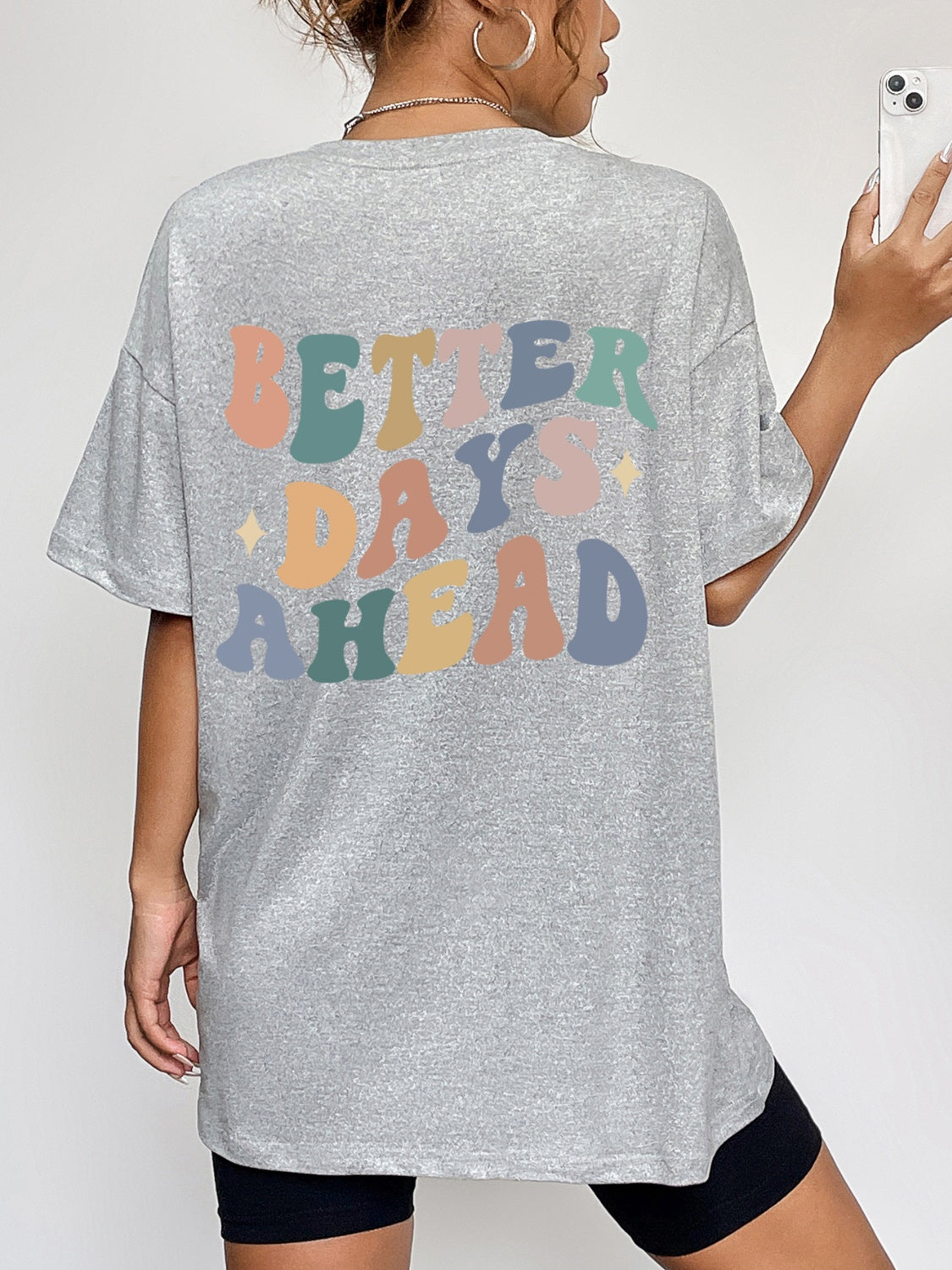 Gray oversized graphic tee with retro "Better Days Ahead" text in pastel colors.
