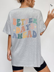 Gray oversized graphic tee with retro "Better Days Ahead" text in pastel colors.