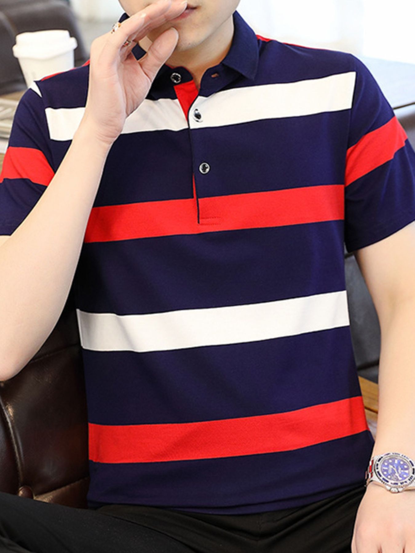 Men's navy, red, and white striped cotton polo shirt with buttoned placket.