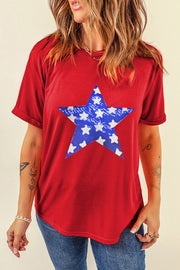 Red cotton blend t-shirt with a distressed blue star graphic and rolled sleeves.