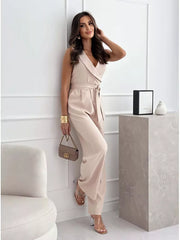 Elegant wrap-front wide-leg romper in Dust Storm with a belted waist and V-neck.
