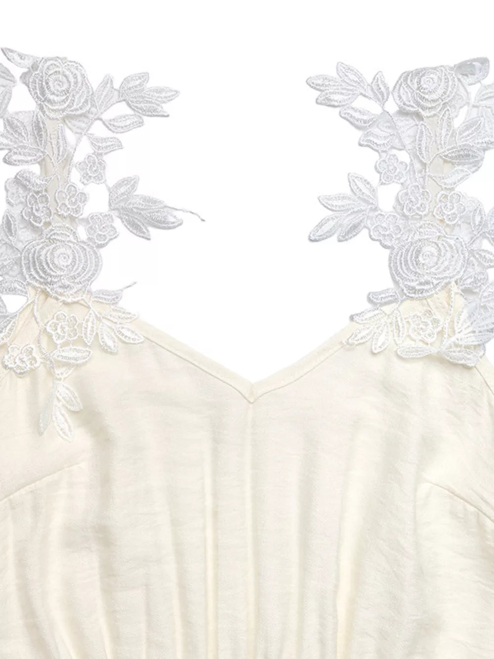 Beige V-neck maxi dress with delicate white lace floral trim on the shoulders.