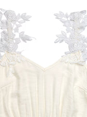 Beige V-neck maxi dress with delicate white lace floral trim on the shoulders.