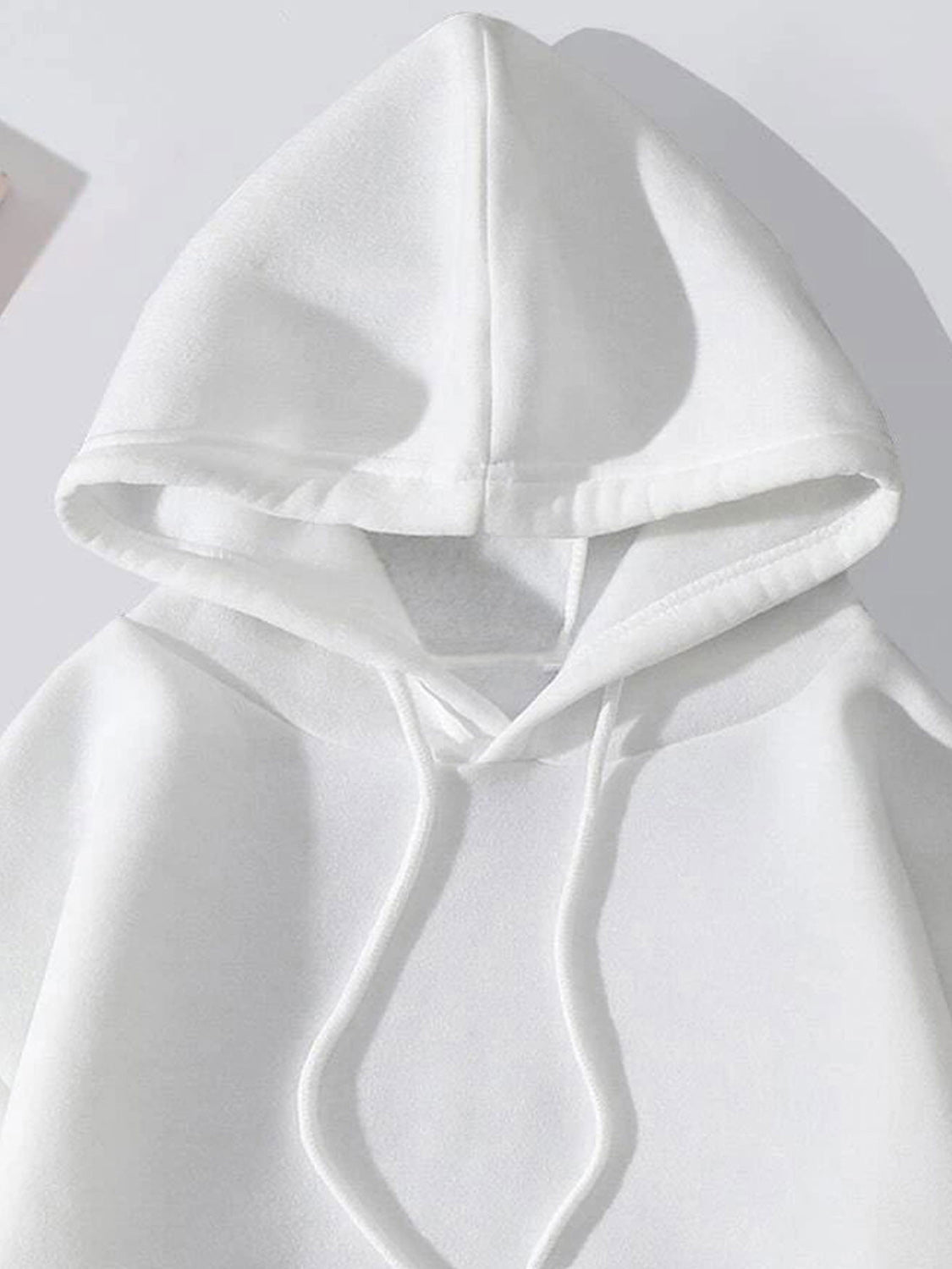 White pullover hoodie with drawstring hood and front pocket detail.