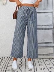 Navy blue striped wide leg pants with drawstring waist and pockets, cuffed hem.