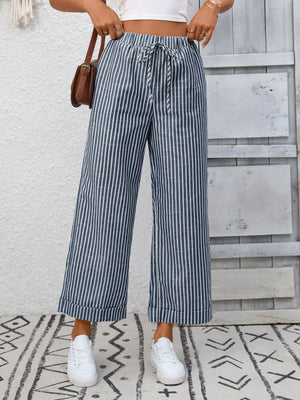 Navy blue striped wide leg pants with drawstring waist and pockets, cuffed hem.