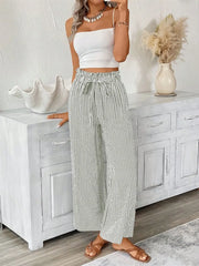 Striped paper bag maternity pants with tie waist and wide leg in black and white.