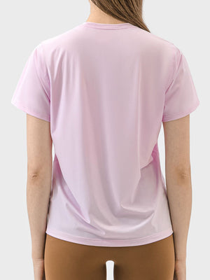 Performance tee in blush pink with short sleeves and a crew neck, showing the back view.