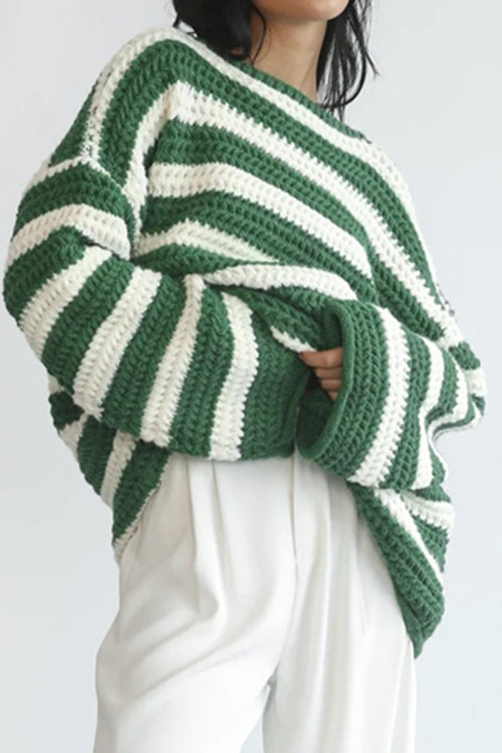 Green and white striped chunky knit sweater with boat neck and wide sleeves.