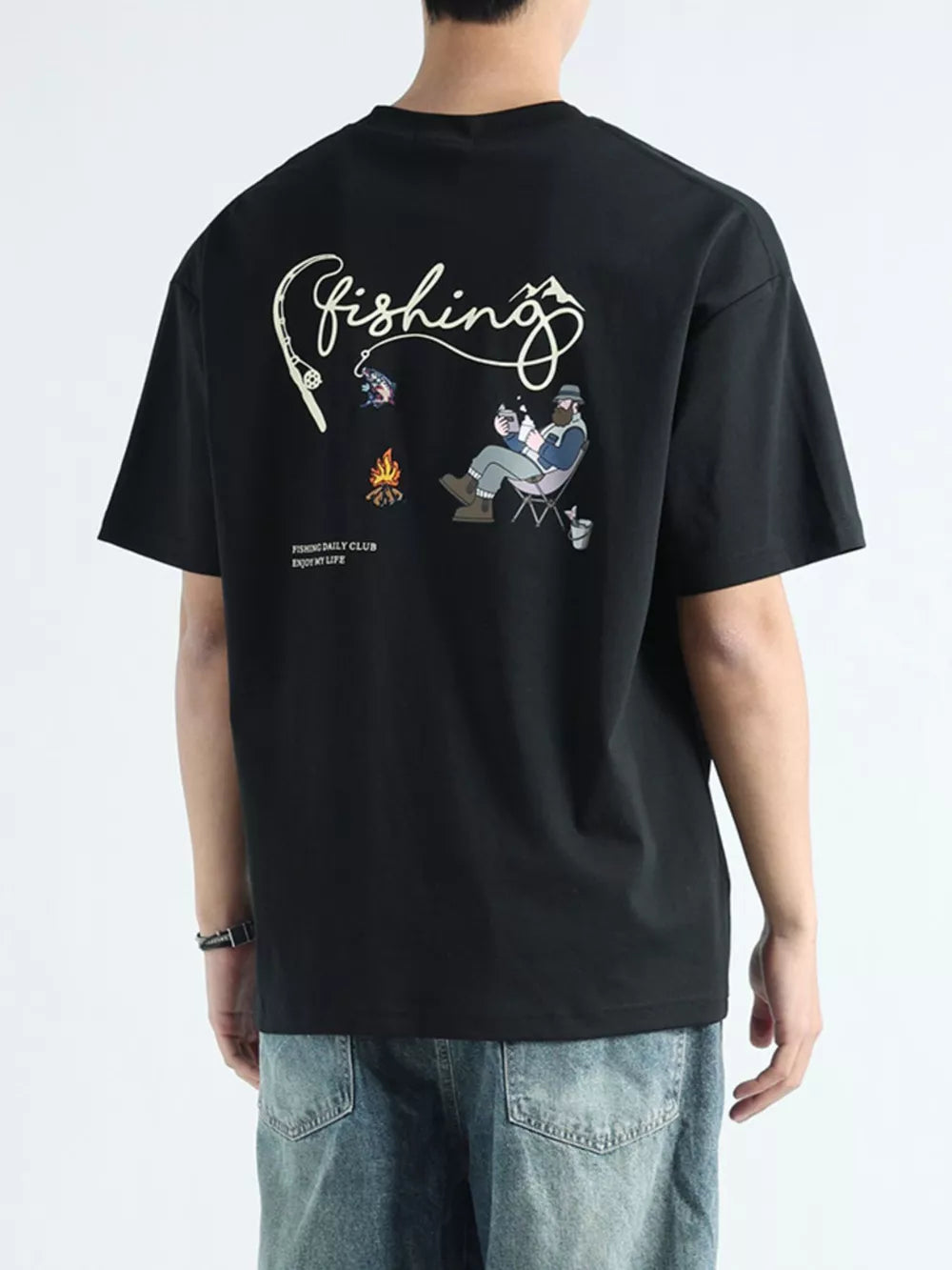 Black cotton graphic tee with fishing scene and text on back.