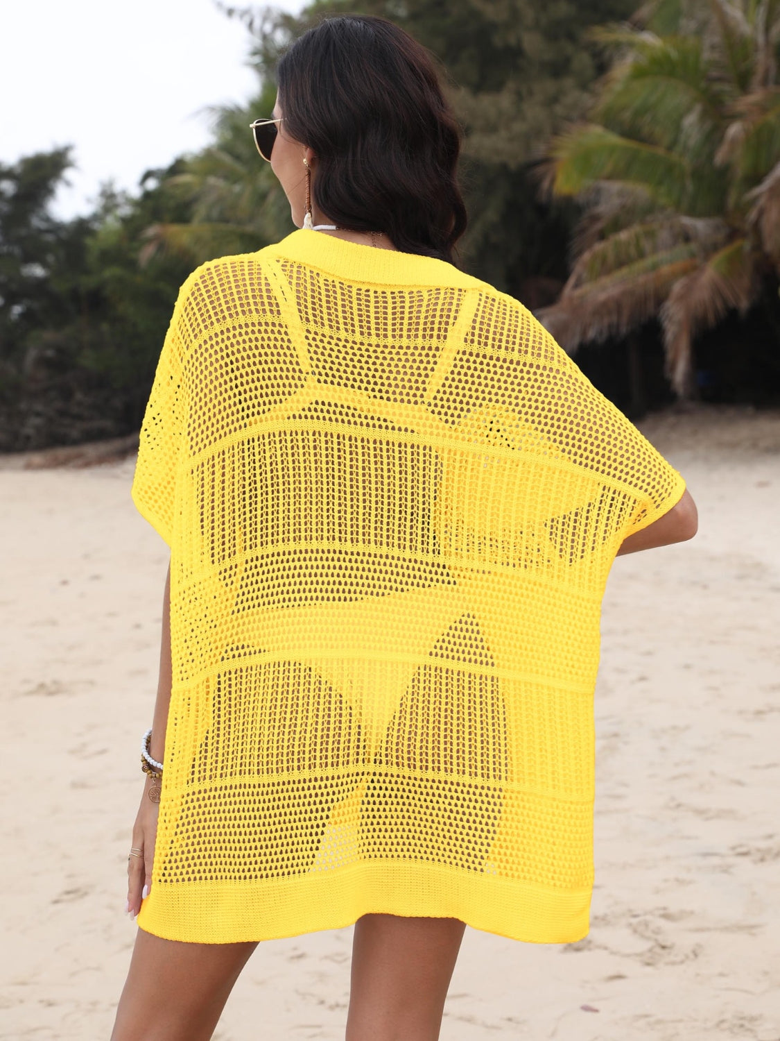 Yellow open-knit polo beach dress with short sleeves and a relaxed fit, worn over a matching swimsuit.