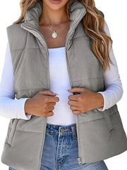 Gray corduroy zip-up vest coat with a stand-up collar and quilted detail.