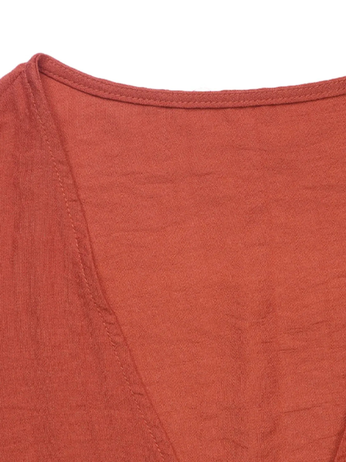 Terracotta linen lounge set top detail with V-neckline and visible stitching
