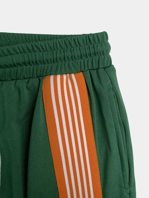 Green athletic-chic two-piece set shorts with orange and white side stripes and elastic waistband.