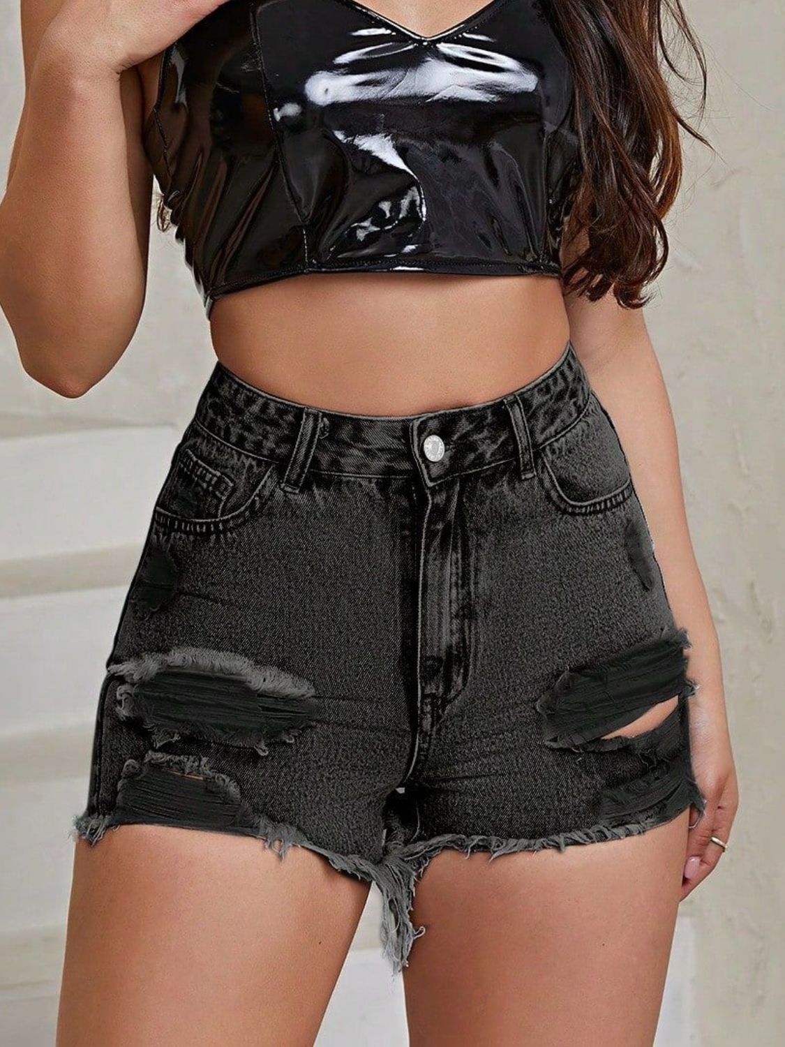 Black distressed denim shorts with frayed hem and ripped details