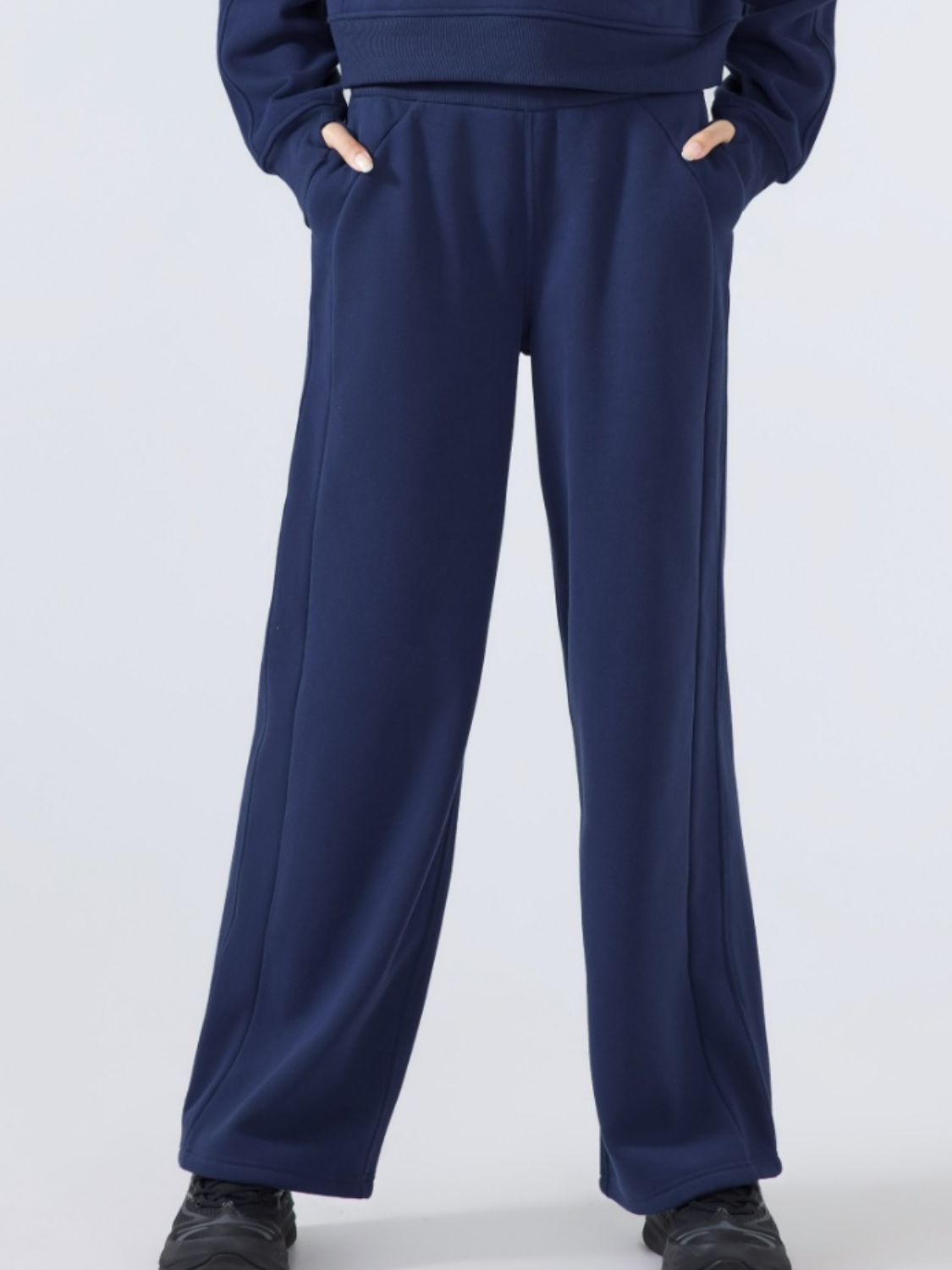 Dark blue relaxed palazzo sweatpants with drawstring waist and pockets.