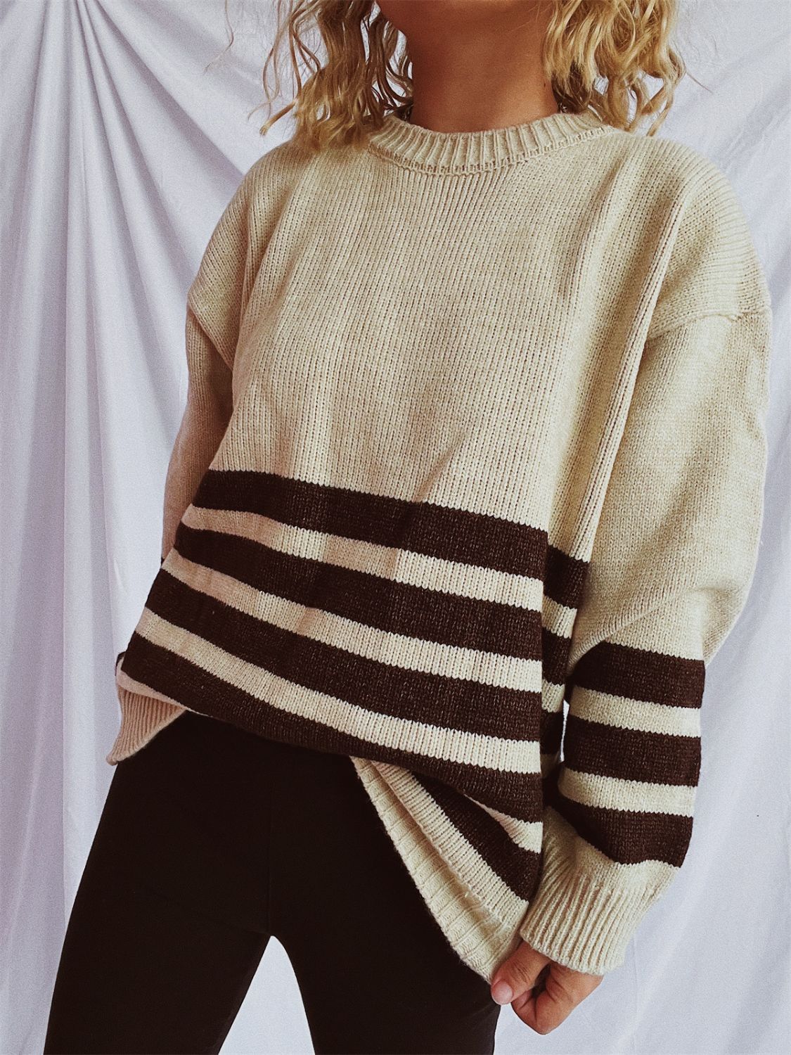 Horizontal stripe ribbed knit sweater in tan with dark brown stripes, crewneck, long sleeves.