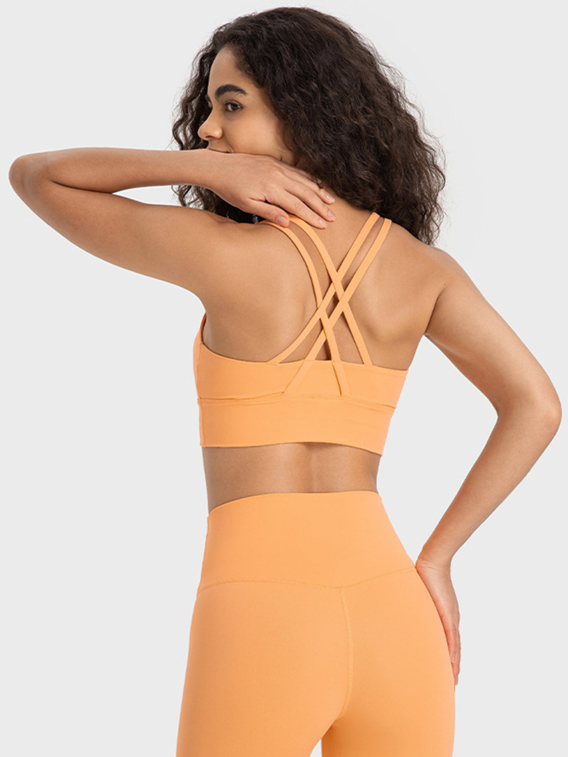 Orange performance bra with crisscross back straps and wide band