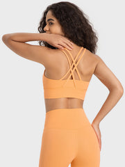 Orange performance bra with crisscross back straps and wide band