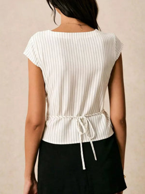 White pinstripe shirt with tie waist and short sleeves.