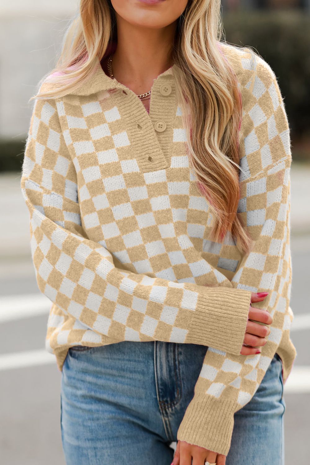 Tan and white checkerboard knit polo sweater with button detail and ribbed cuffs.