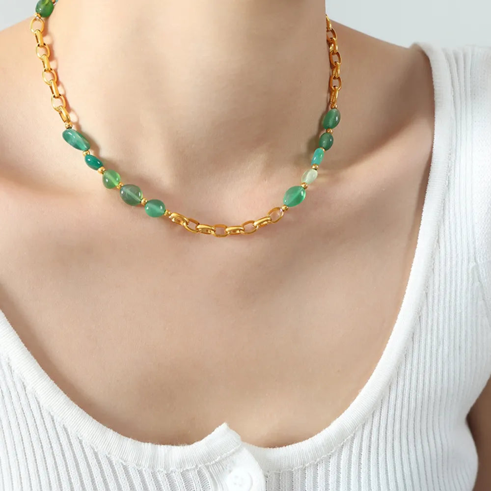Green beaded necklace with gold chain, featuring oval and round beads.