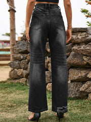 Distressed black flare denim jeans with frayed hem detail.