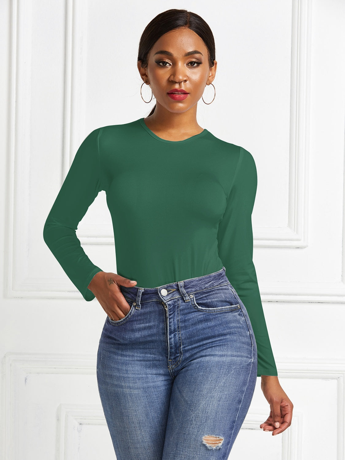 Dark Green ribbed jersey bodysuit with long sleeves and a crew neck, styled with denim jeans.