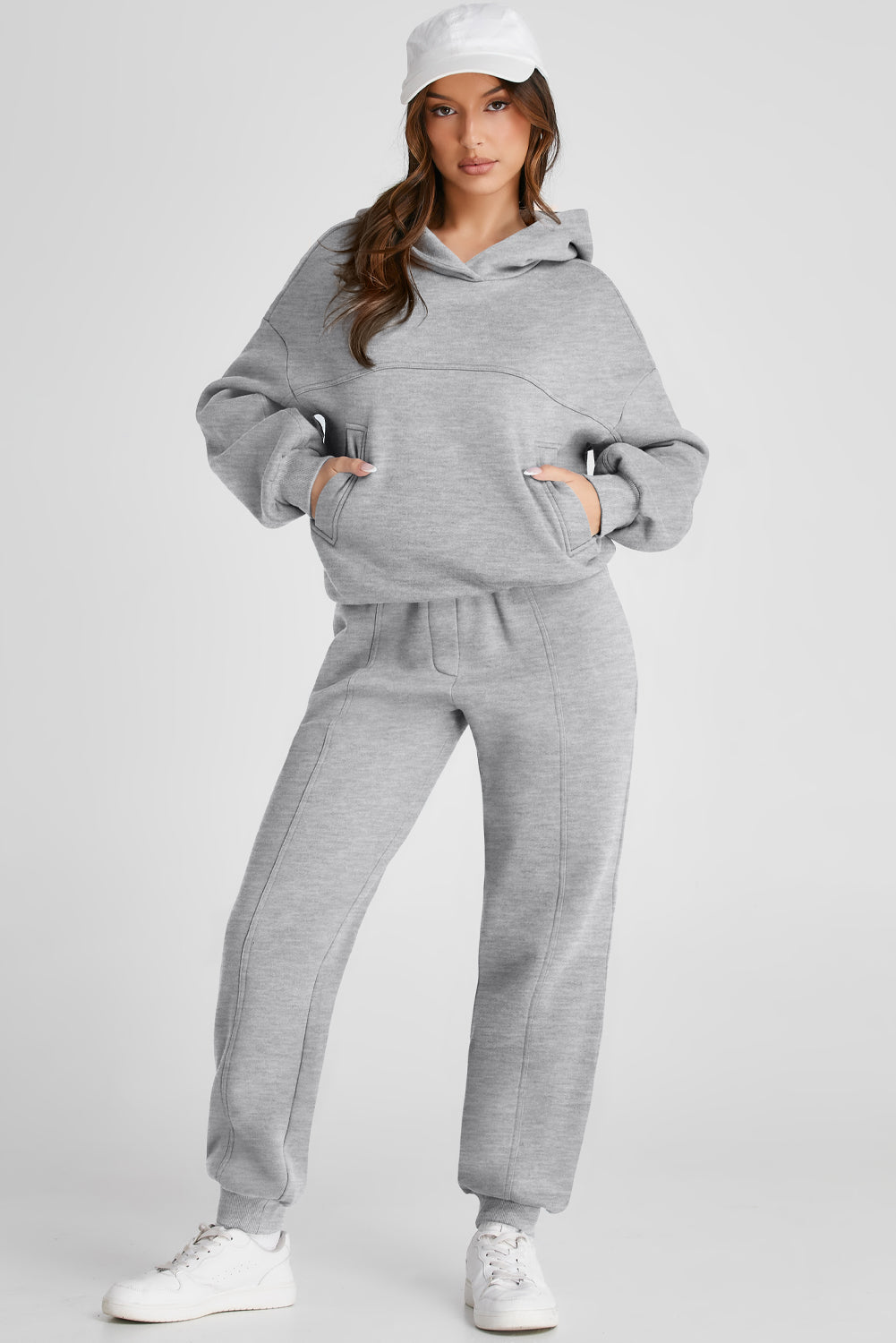 Gray relaxed fit lounge set with seam detail, featuring a hooded sweatshirt with pockets and matching joggers.