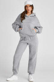 Gray relaxed fit lounge set with seam detail, featuring a hooded sweatshirt with pockets and matching joggers.