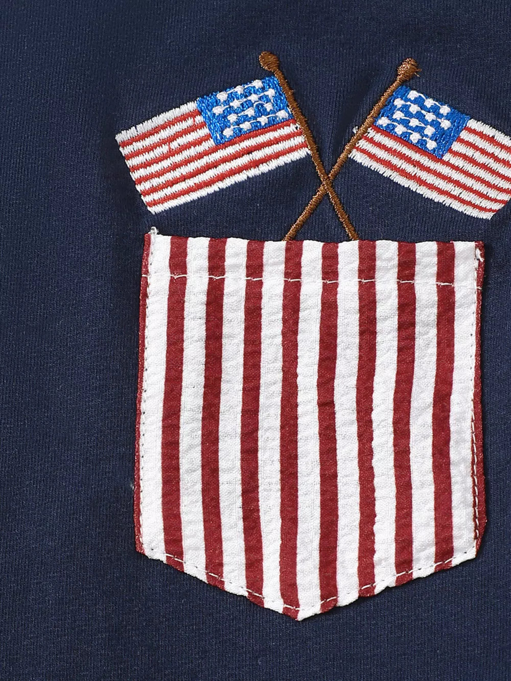 Navy tee with embroidered American flags over a red and white striped pocket detail.
