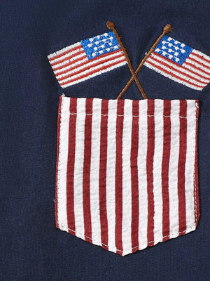 Navy tee with embroidered American flags over a red and white striped pocket detail.