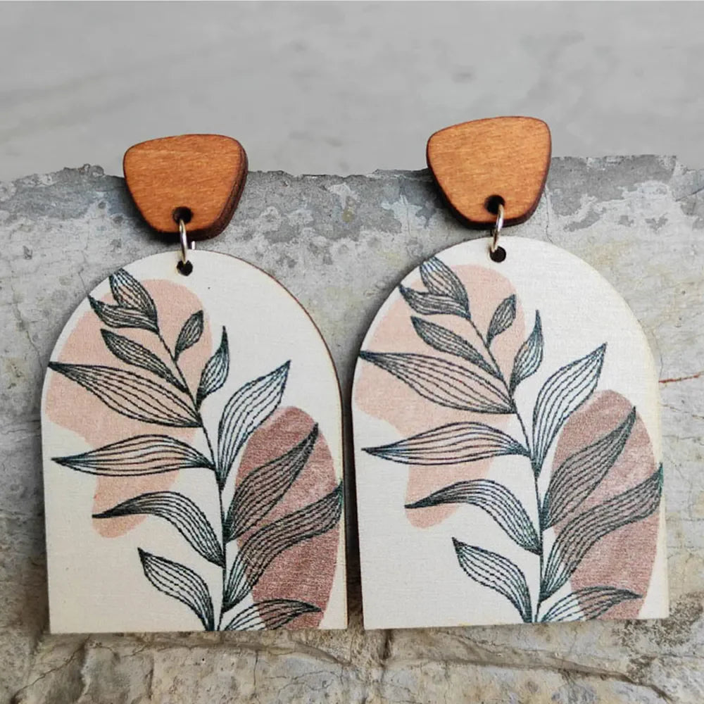 Botanical arch wood earrings in apricot with abstract leaf print and wooden top detail.