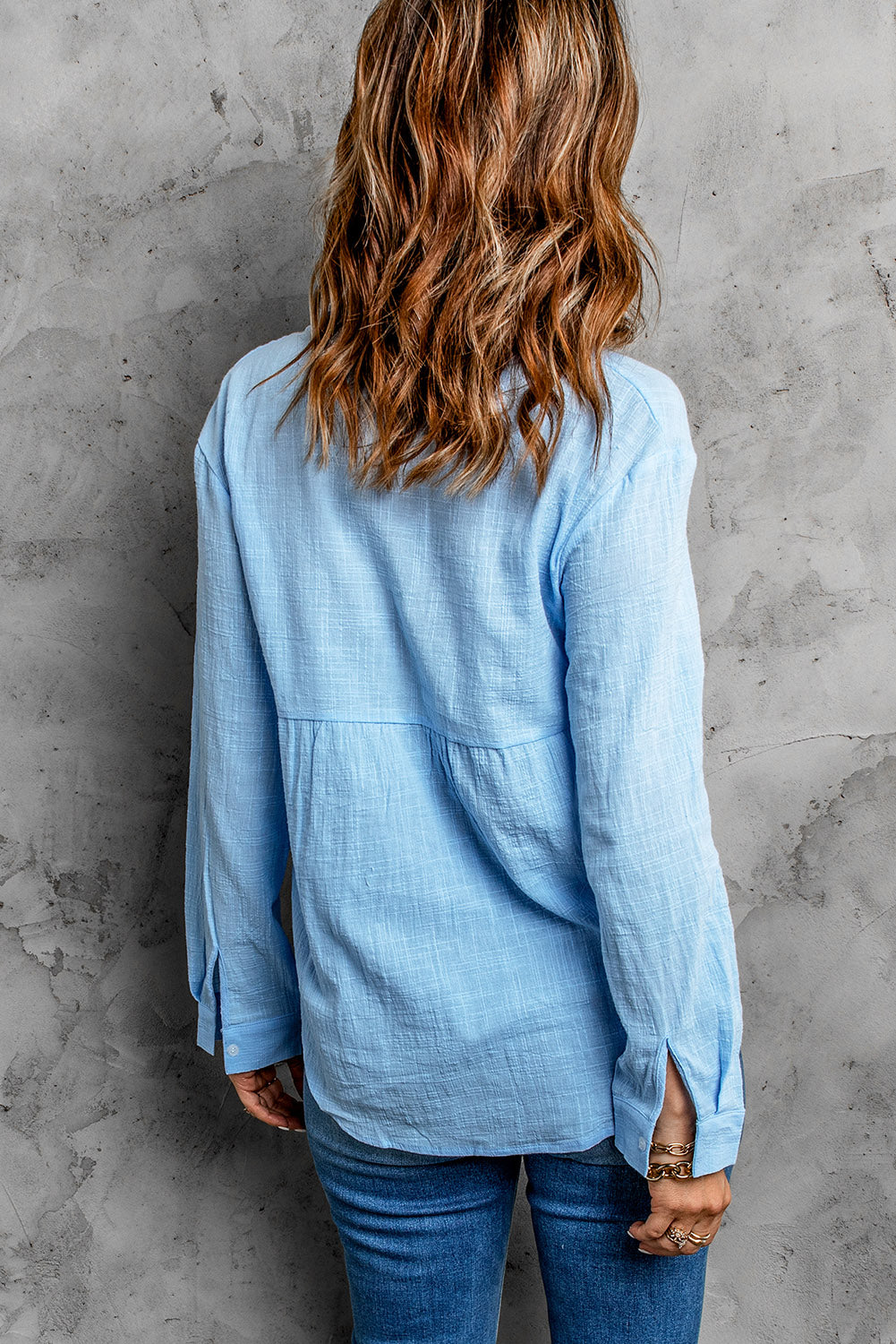 Light blue textured cotton relaxed fit shirt with button cuffs and a tiered bodice detail.