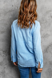 Light blue textured cotton relaxed fit shirt with button cuffs and a tiered bodice detail.