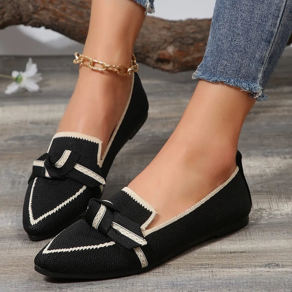 Black knit bow loafers with contrast trim and pointed toe.