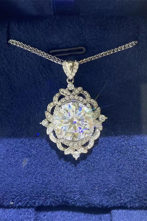Silver filigree halo diamond pendant necklace with intricate floral details.