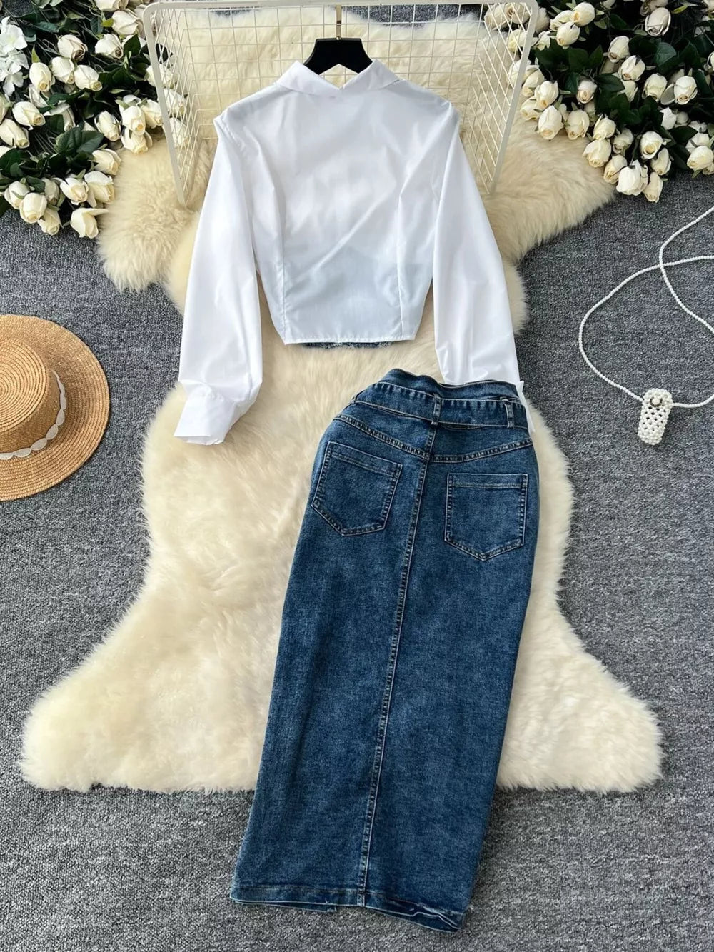 White collared long sleeve crop top and blue denim maxi skirt with slit detail.