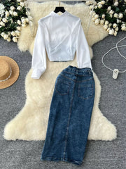 White collared long sleeve crop top and blue denim maxi skirt with slit detail.